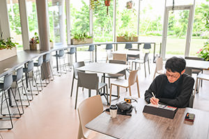 The café envelops visitors in soothing greenery and aroma