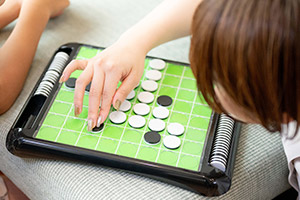 Playing a game with the owner’s child in her spare time